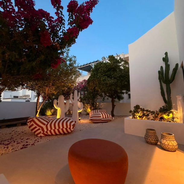 Private garden with bougainvillea, cactus and outdoor lounge seating at Bluewaves Antiparos Moonstone Jacuzzi House
